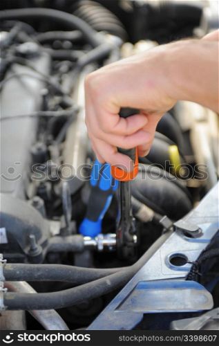 mechanic repairing a car at service station
