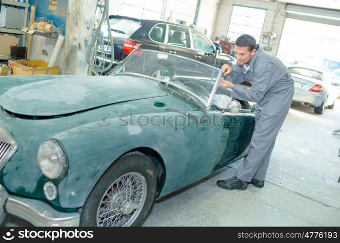 mechanic repairing classic car