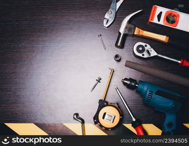 Mechanic tools on wooden background with copy space,drill,screwdriver,hammer,level,spanner,measuring tape,rasp,pliers,bolt