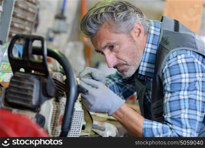 Mechanic working on gardening equipment