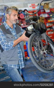 Mechanic working on motorised bicycle