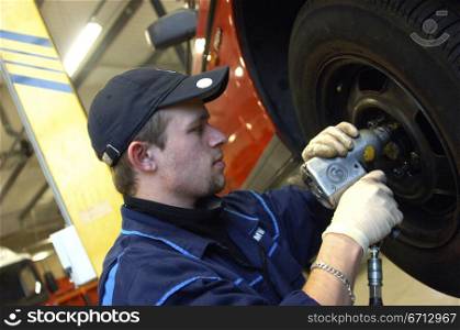 mechanic working on wheel