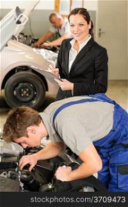 Mechanics and female manager working in repair shop