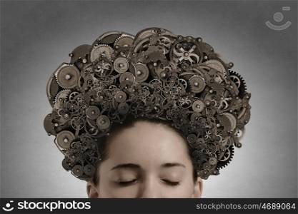 Mechanisms of thinking processes. Thinking businesswoman with gear mechanisms on her head