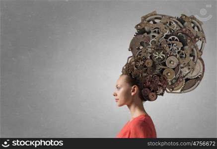 Mechanisms of thinking processes. Thinking businesswoman with gear mechanisms on her head