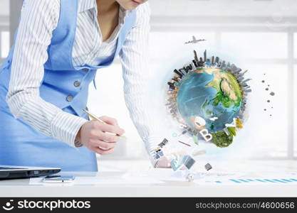 Mechanisms of world organization. Close view of businesswoman writing with pen. Elements of this image are furnished by NASA