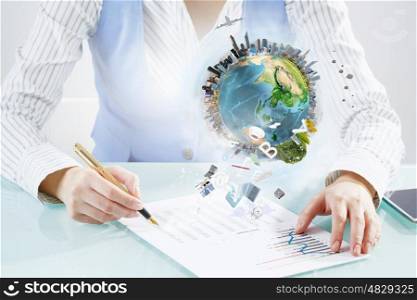 Mechanisms of world organization. Close view of businesswoman writing with pen. Elements of this image are furnished by NASA