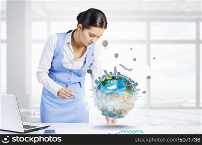 Mechanisms of world organization. Young smiling businesswoman working in office. Elements of this image are furnished by NASA
