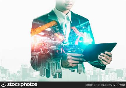 Mechanized industry robot arm and factory worker double exposure . Concept of robotics technology for industrial revolution and automated manufacturing process .. Mechanized industry robot arm and factory worker double exposure