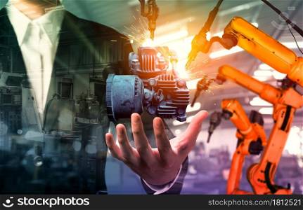 Mechanized industry robot arm and factory worker double exposure . Concept of robotics technology for industrial revolution and automated manufacturing process .. Mechanized industry robot arm and factory worker double exposure