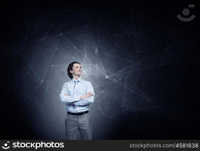 Media connection concept. Confident businessman with arms crossed on chest on background of connection concept