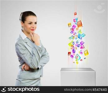 Media icons. Image of businesswoman looking at media icons. Modern technologies