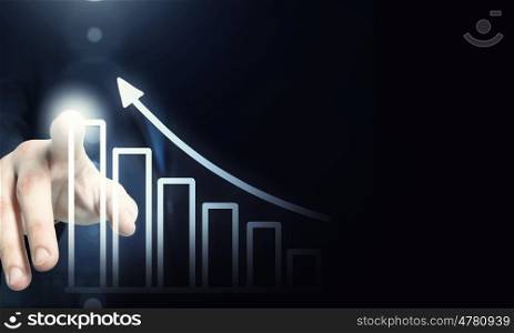Media interface. Businessman hand pushing business graph on touch screen interface