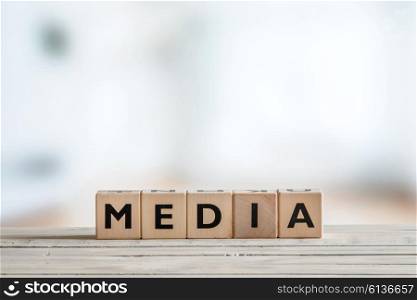 Media sign made of blocks on a wooden table