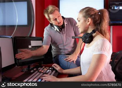 Media Student With Tutor Working In Film Editing Class