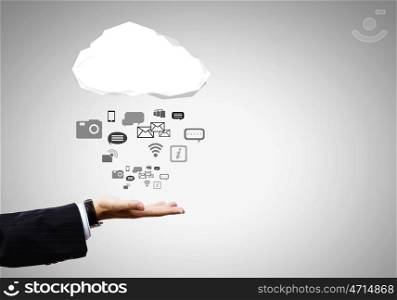 Media symbols. Close up of businessman hand holding cloud with media icons