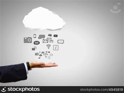 Media symbols. Close up of businessman hand holding cloud with media icons