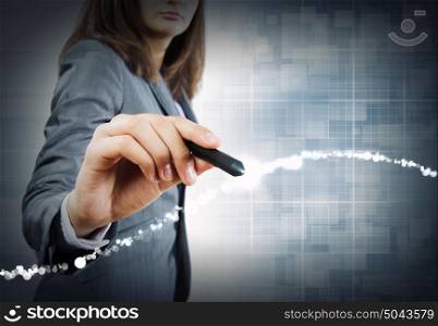 Media technologies. Close up of businesswoman drawing on media screen with pen