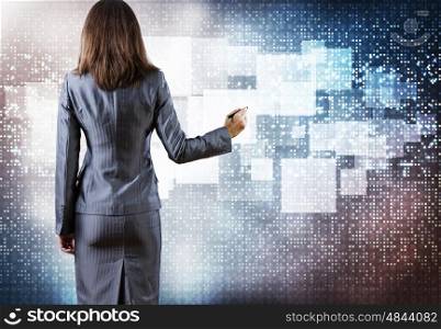 Media technologies. Rear view of businesswoman touching media screen with stylus