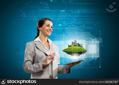 Media technologies. Young businesswoman with tablet pc in hands. Ecology concept