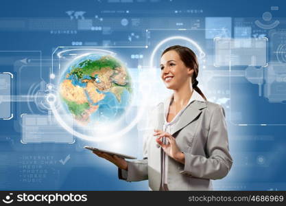 Media technologies. Young businesswoman with tablet pc in hands. Globalization concept. Elements of this image are furnished by NASA