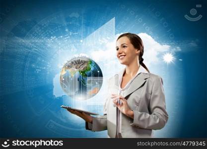 Media technologies. Young businesswoman with tablet pc in hands. Globalization concept. Elements of this image are furnished by NASA