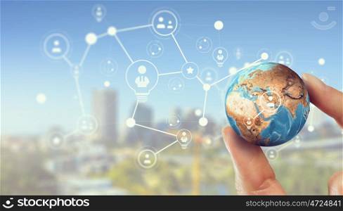 Media worldwide technology concept. Female hand holding Earth planet between fingers. Elements of this image are furnished by NASA