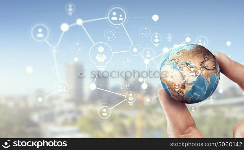Media worldwide technology concept. Female hand holding Earth planet between fingers. Elements of this image are furnished by NASA