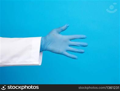 medic in a white coat, blue latex gloves pulls his hand for a handshake on a blue background