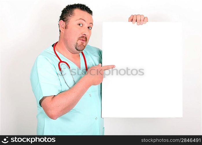 Medic in scrubs pointing at a board left blank for your image