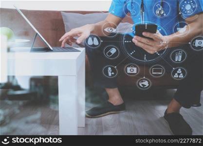 Medical and Health context,doctor hand working with smart phone,digital tablet computer,stethoscope,sitting on sofa in living room,virtual interface graphic icons diagram