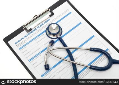 Medical and health insurance claim form with stethoscope on clipboard isolated