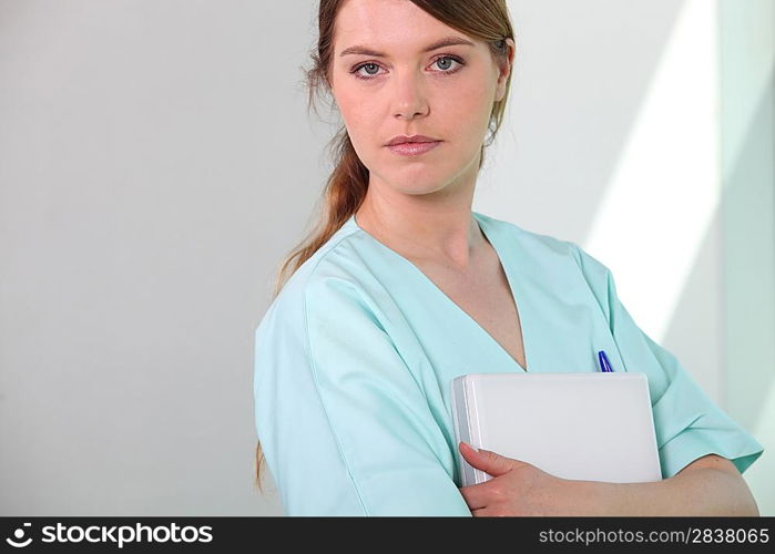 Medical assistant holding a patient file