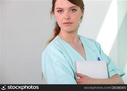 Medical assistant holding a patient file