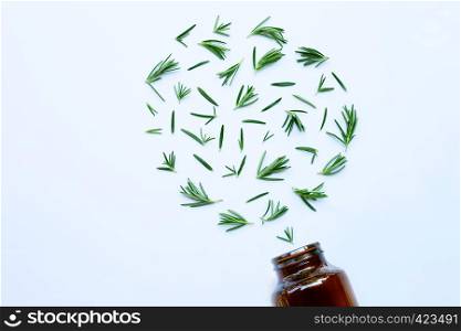 Medical bottle glass with fresh rosemary leaves isolated on white background. Heart shape