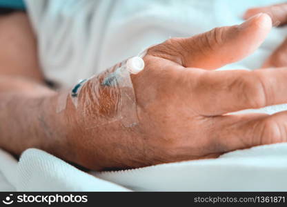 Medical Care, Close up image of IV drip in patient's hand in hospital.