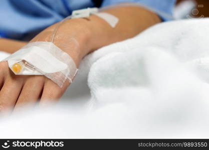 Medical Care, Close up image of IV drip in patient s hand in hospital.