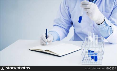medical chemist / scientist student experiments test tube in laboratory