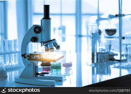 Medical Chemists Scientific equipment. Laboratory Microscope healthcare,Microscope in microbiology lab with laboratory glassware background for medical research or science development concept.
