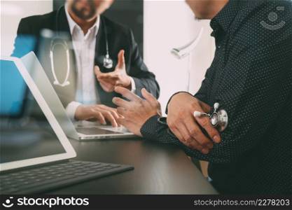 Medical co working concept,Doctor working with digital tablet and laptop computer formeeting his team in modern office at hospital