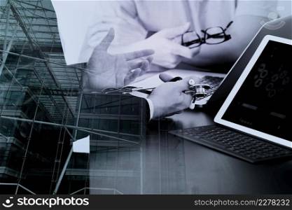 Medical co working concept,Doctor working with smart phone and digital tablet and laptop computer to meeting his team in modern office at hospital with London city exposure
