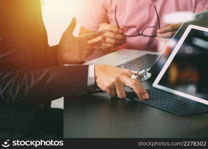 Medical co working concept,Doctor working with smart phone and digital tablet and laptop computer to meeting his team in modern office at hospital