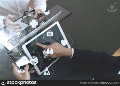 Medical co working concept,Doctor working with smart phone and digital tablet and laptop computer to meeting his team in modern office at hospital with virtual diagram