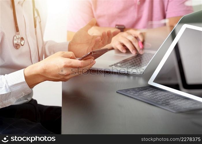 Medical co working concept,Doctor working with smart phone and digital tablet and laptop computer to meeting his team in modern office at hospital