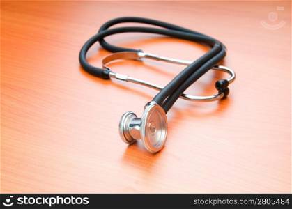 Medical concept - stethoscope on the wooden table