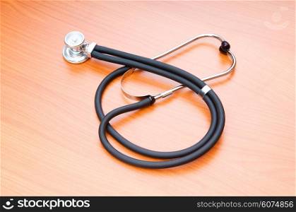 Medical concept - stethoscope on the wooden table