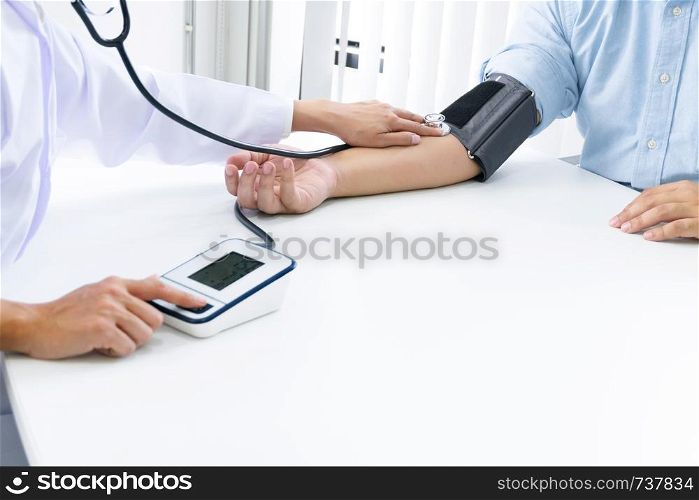 Medical doctor checking pressure with patient in hospital.