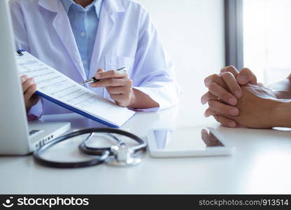 Medical Doctor consultant with patient in clinic office or hospital.