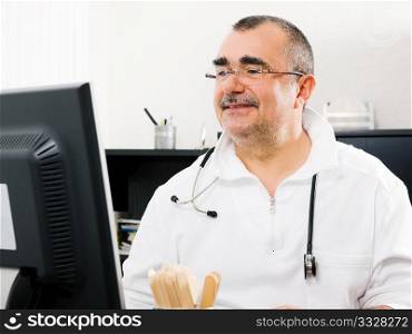Medical doctor doing some office stuff using his computer (focus on eyes)