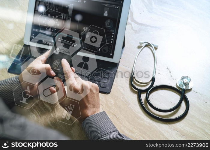 medical doctor hand working with smart phone,digital tablet computer,stethoscope eyeglass,on wooden desk,virtual graphic interface icons screen